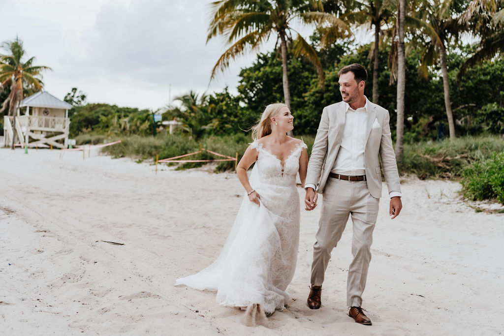 Couple walking hand in hand on the beach