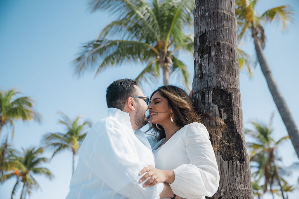 Couple kissing under palm trees